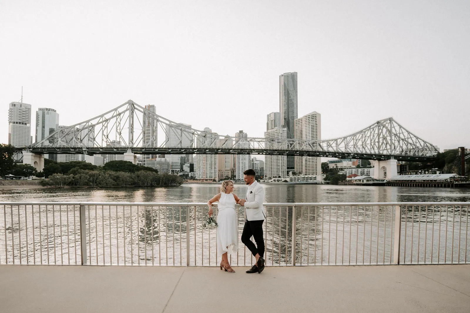 Shannon and Jacksen small against the Story Bridge and the Brisbane skyline