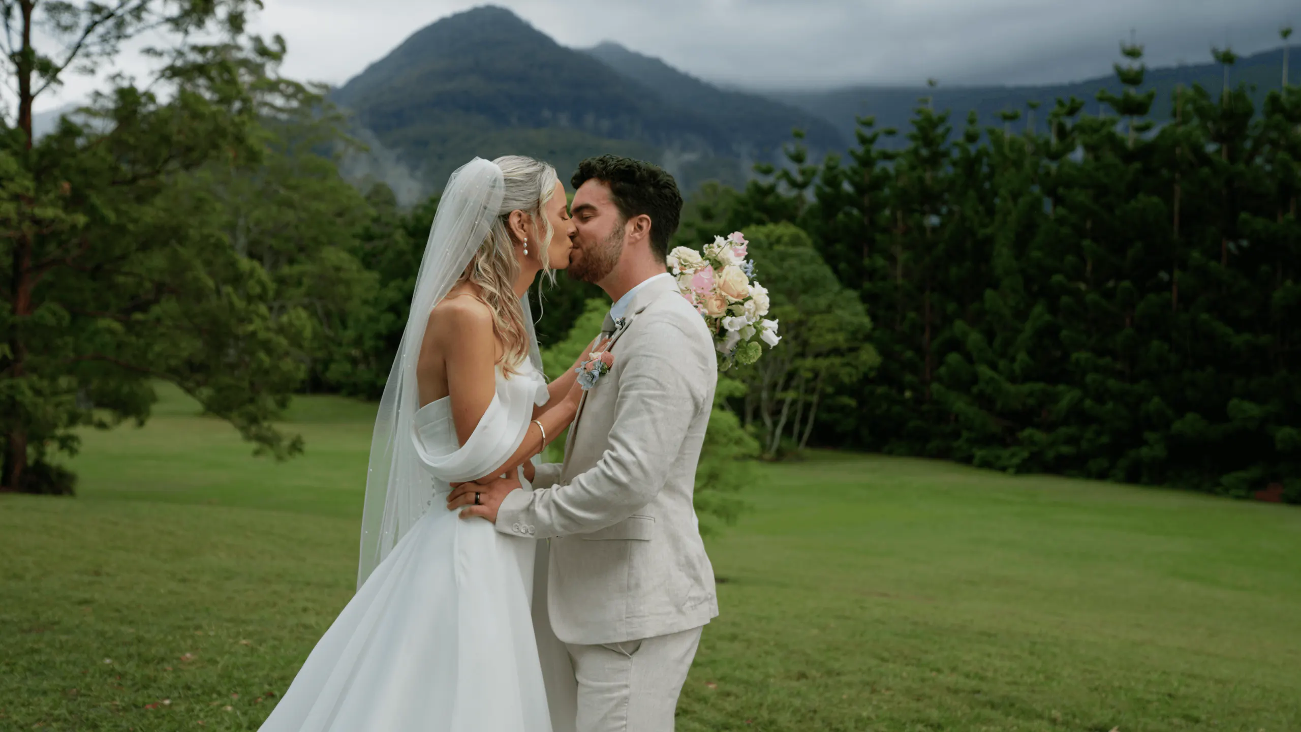Shontae and Lachlan kissing in front of the hinterland